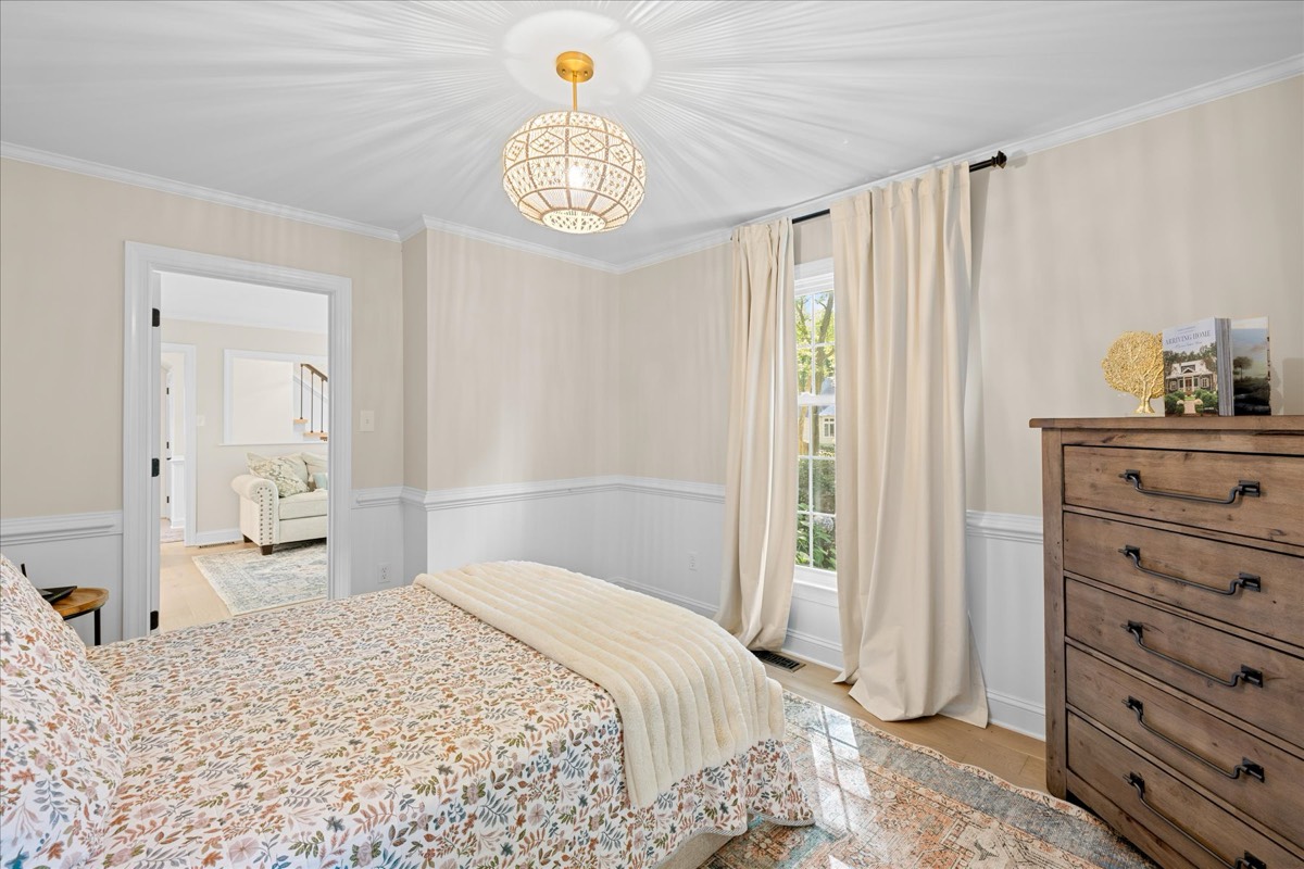 Bedroom with floral bedding and dresser